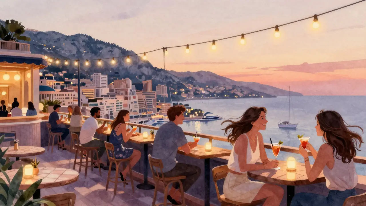Rooftop bar at sunset with guests overlooking Monaco&#039;s harbor and the Rock.