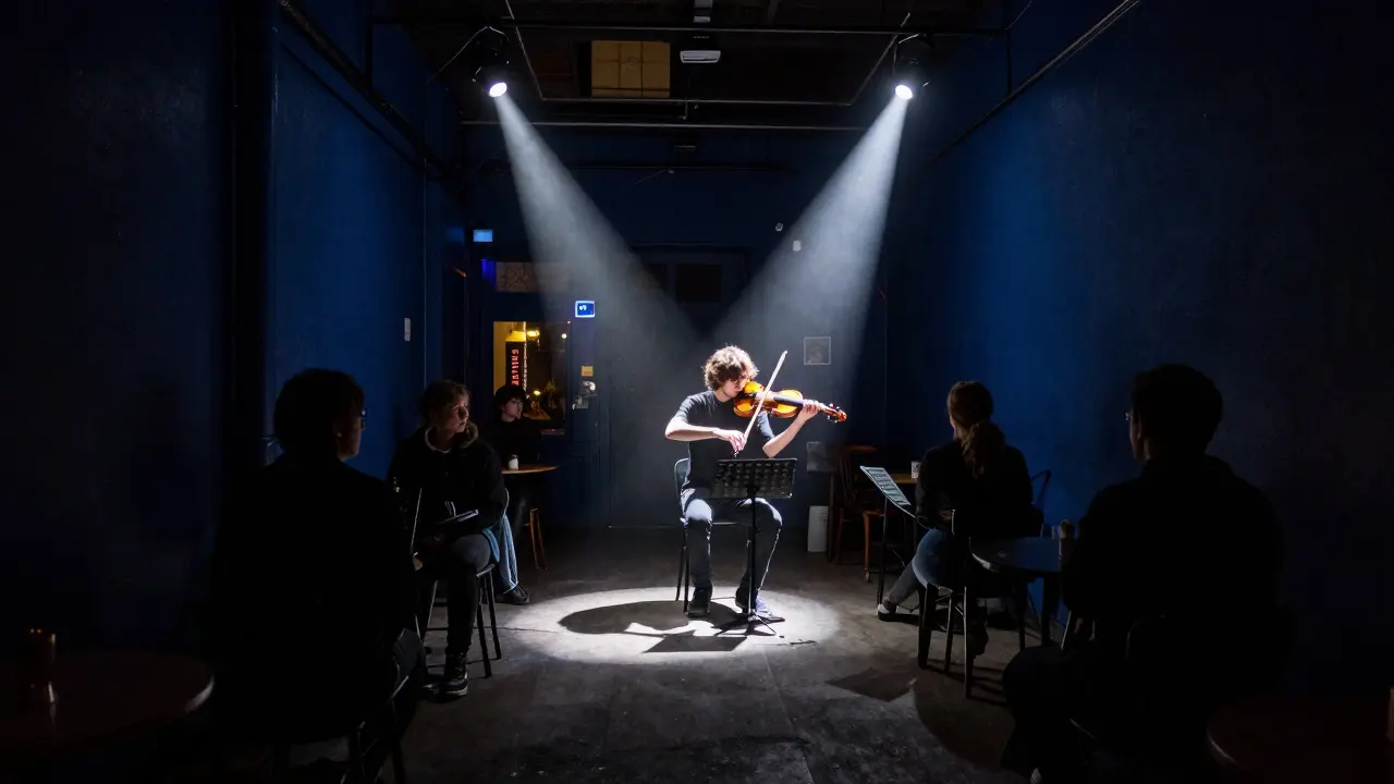 An experimental music venue at midnight with a musician using a violin bow to create sound.